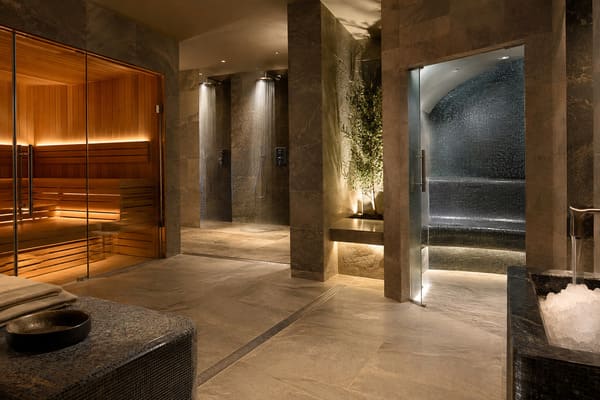 Hotel spa design with a timber sauna, steam room entrance and relaxation area